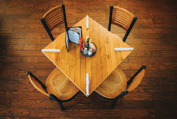 Four chairs around table with place settings at Swingbelly's Michigan City restaurant.